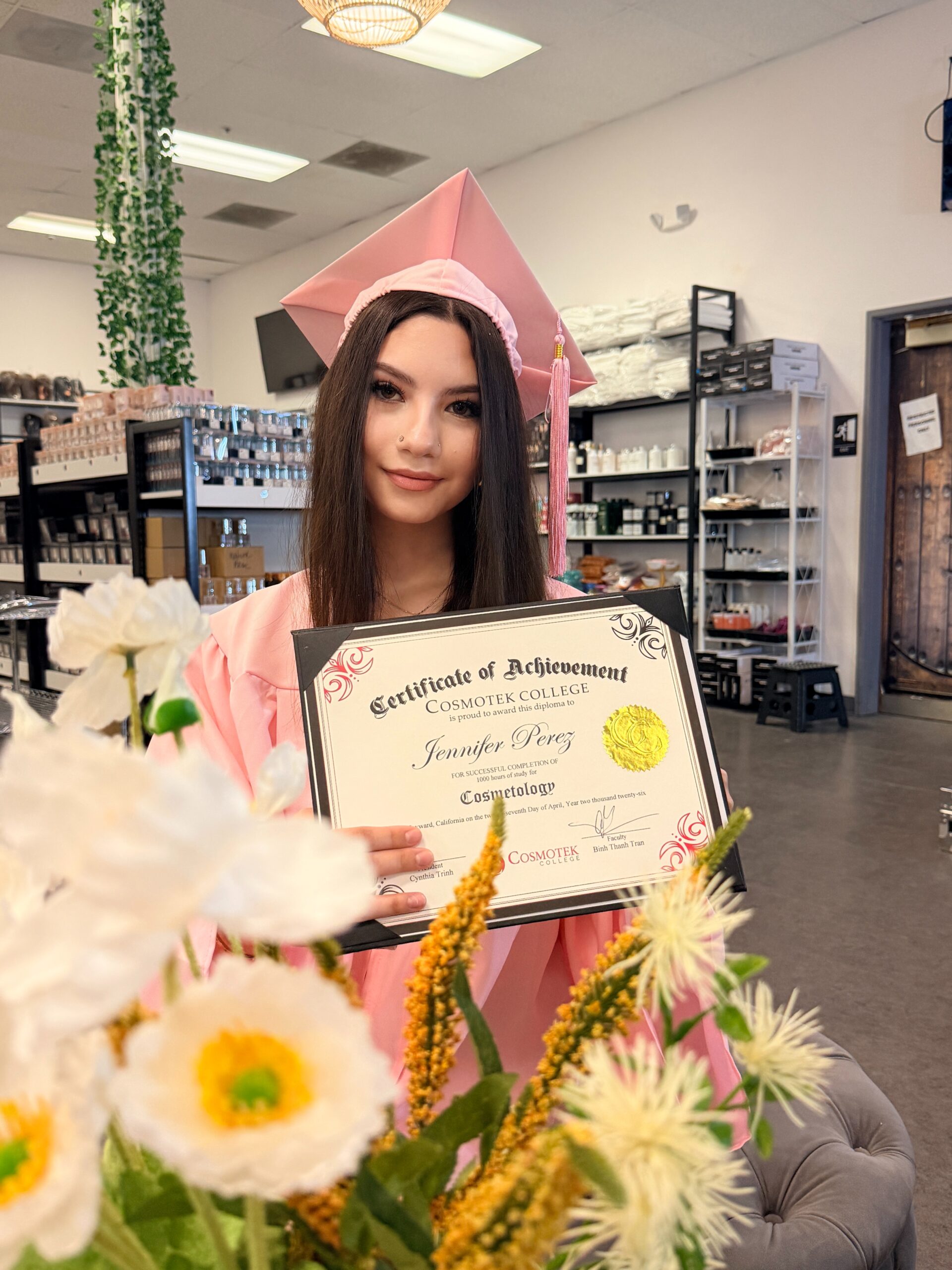 Cosmetology graduate holding her certificate